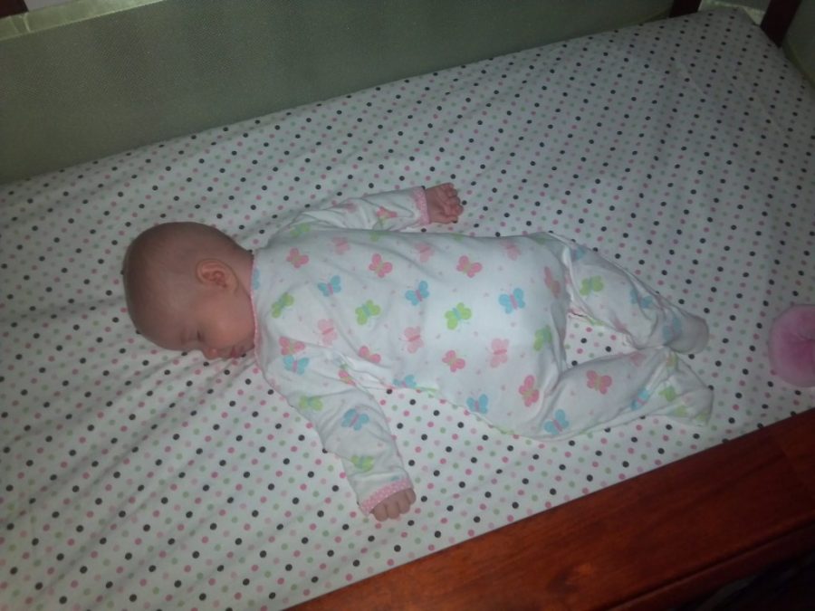 Sleeping sweetly, in her crib, all night long