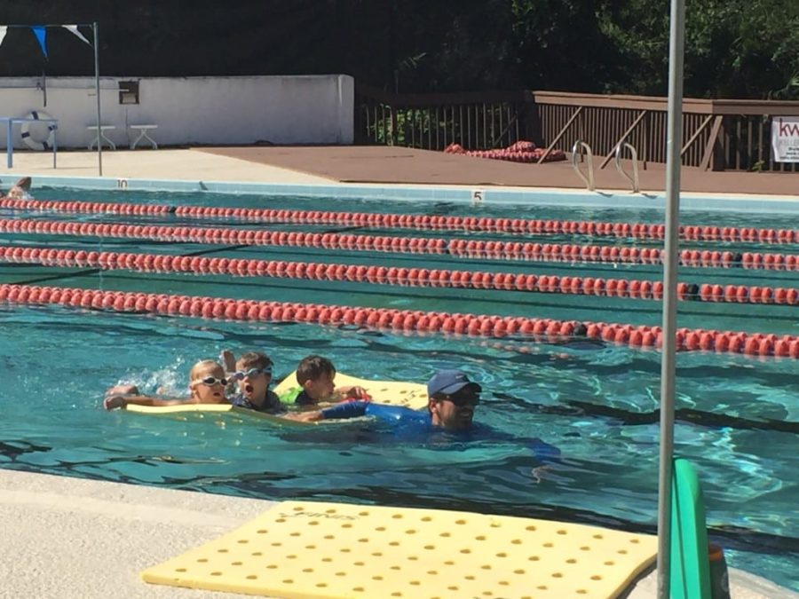 Loving the "cheese float" with swim instructor, Jack.